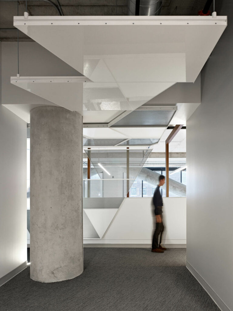 white hanging platforms define the ceiling of an office