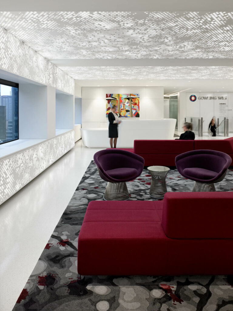 maroon lounge seating in front of two purple accent chairs in a reception area 