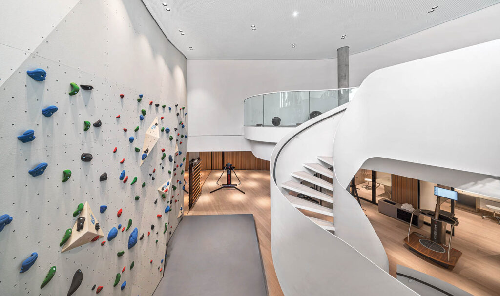 a climbing wall next to a staircase