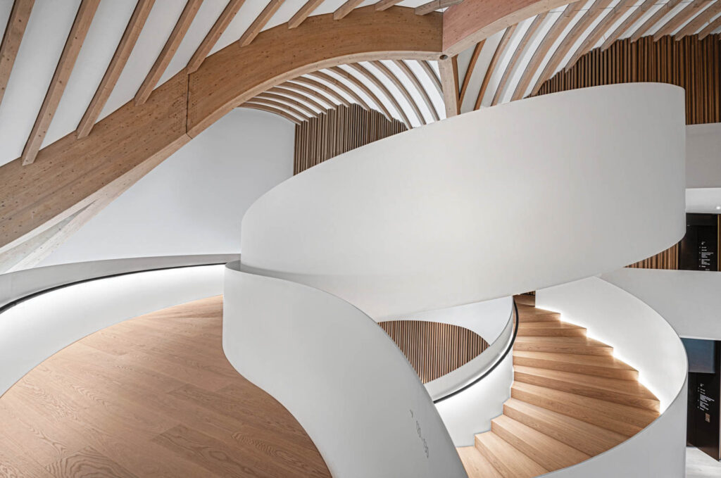 a white spiral staircase with wooden steps