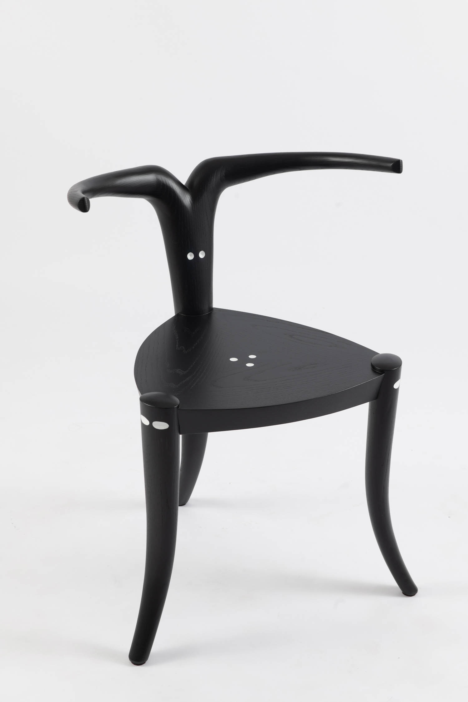 A black chair with horn-shaped back referencing the Nyala antelope. 