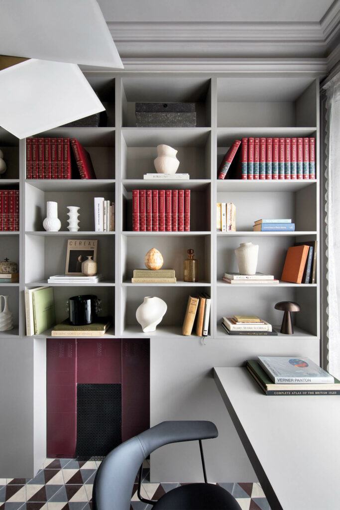 a studey with built in shelves filled with books and accessories