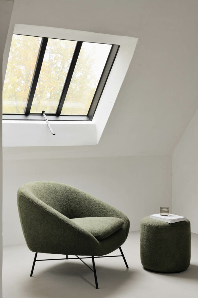 a green lounge chair and pouf