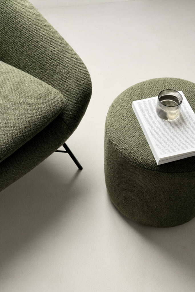 a close up of a green lounge chair and pouf