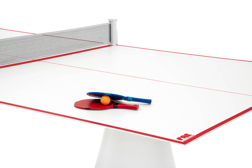 ping pong paddles and a ball on an outdoor tennis table