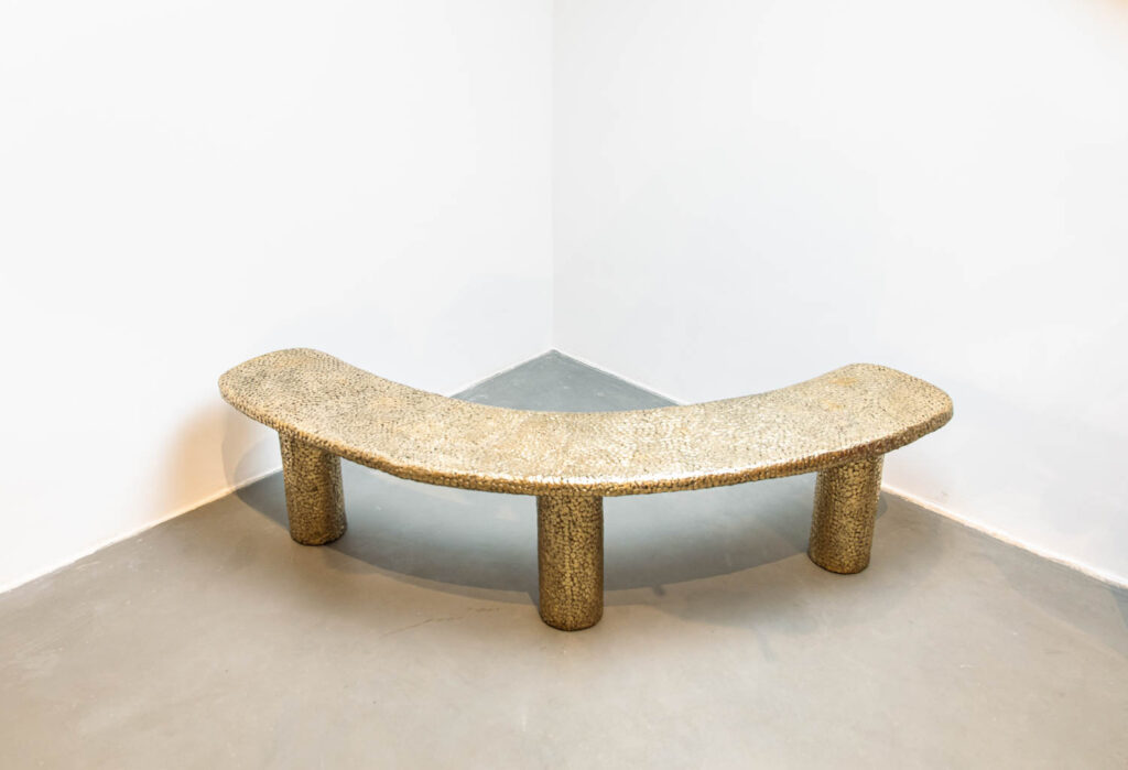 a curved bronze bench