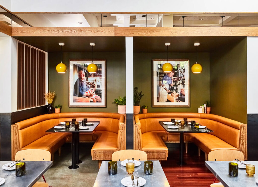 dining nooks in this restaurant with portraits of James Beard and Julia Child hanging above