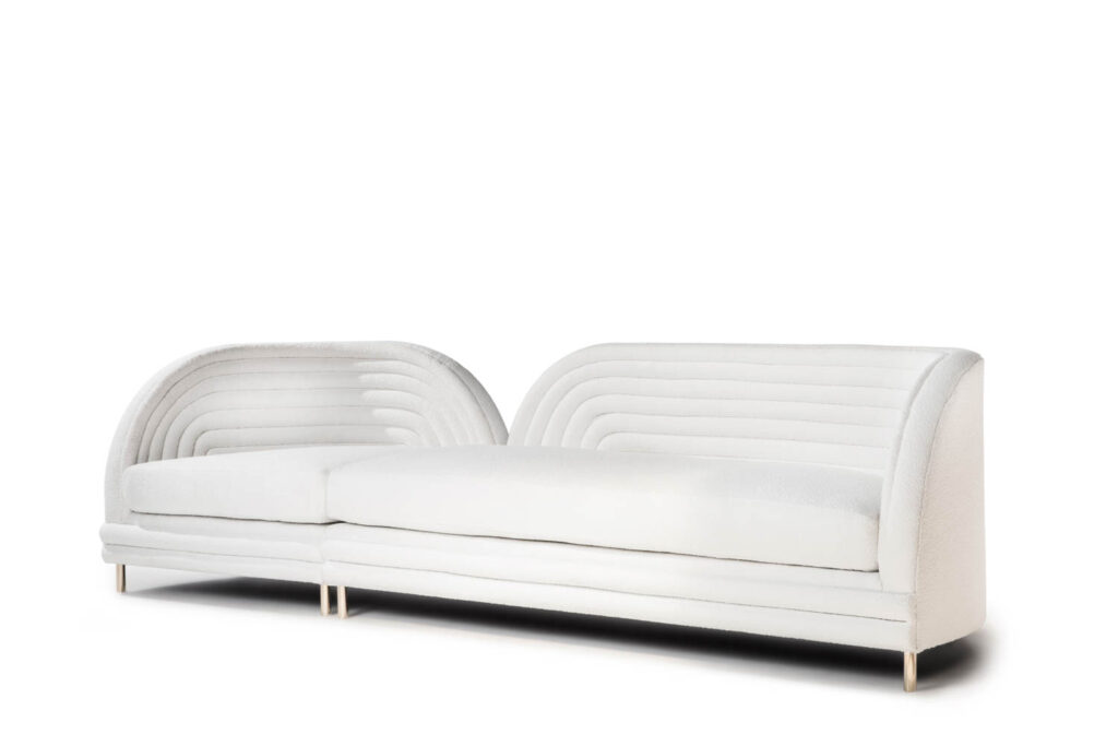 The Noodle sofa by Thabiso Mjo in white features a high back with noodle-shaped lines that curve around it.