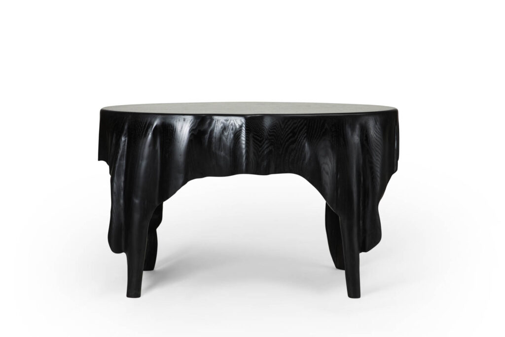 The Art of Measuring table features fluid waves and a black finish. 