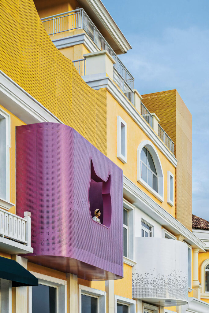 a cat head cut out in aluminum on the balcony of a bookstore