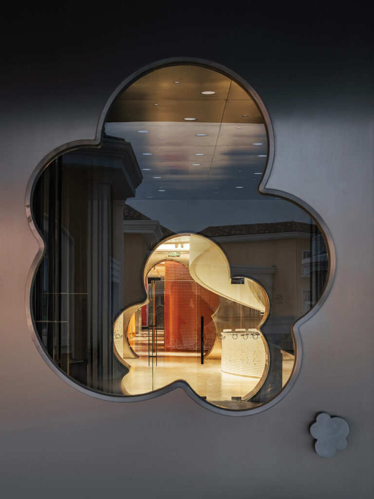 a cloud shape cut out of a titanium window