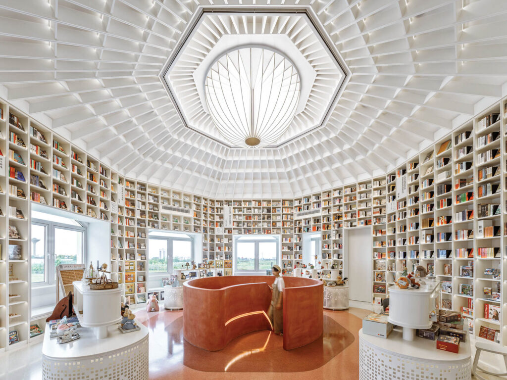 books fill the shelves under a white octagonal ceiling