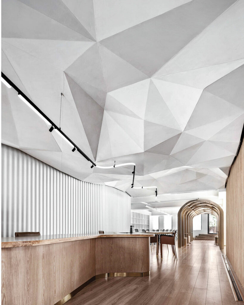 Geometric patterns create visual interest in the ceiling marking a contrast from the wood floors below.