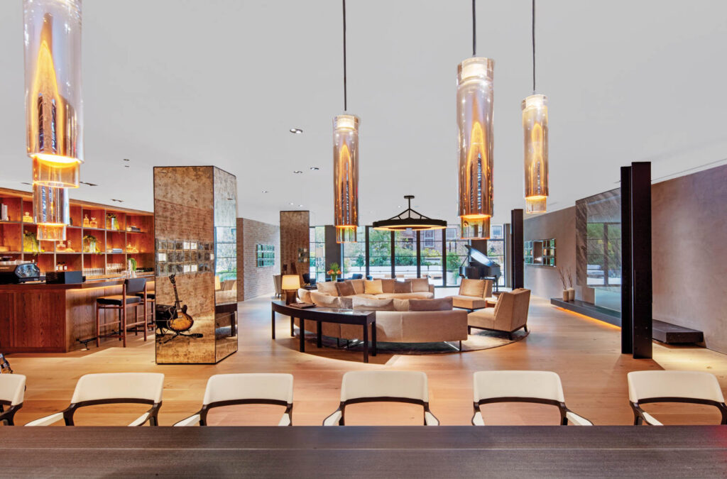 cylindrical pendant lights hang in the lounge area of AP House