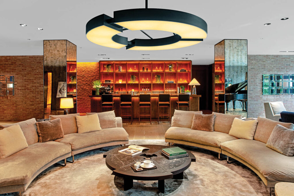 a chandelier hangs above sofas in the lounge at AP House