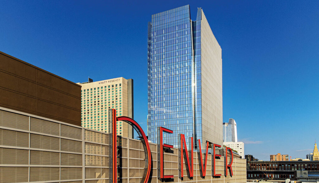 the top corner of an office tower that is split to look like a rock crevice