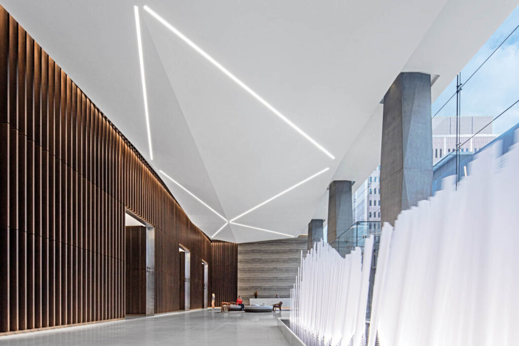 the lobby of an office tower with exposed-concrete columns