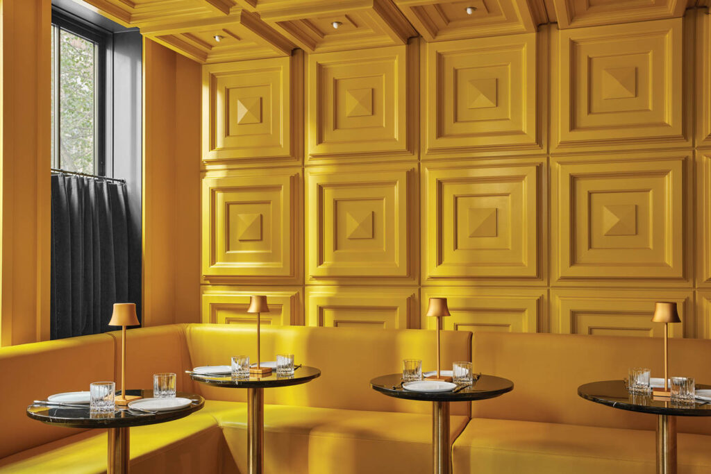 yellow banquette seating against a yellow wall 