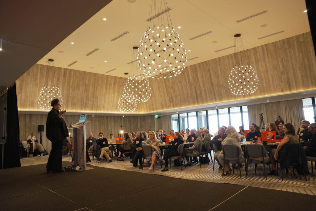 Guests fill a ballroom in the Alila Marea Beach Resort during the event