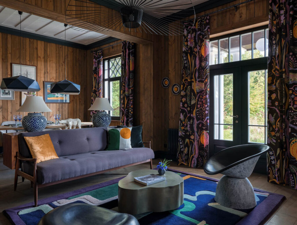 custom curtains with floral motifs in a wood paneled room in Mia Karlova's home