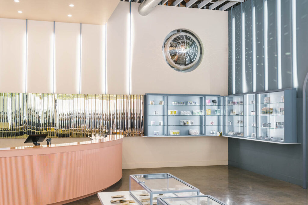 a peach-colored check out counter next to a disco ball set in the wall of Green Qween