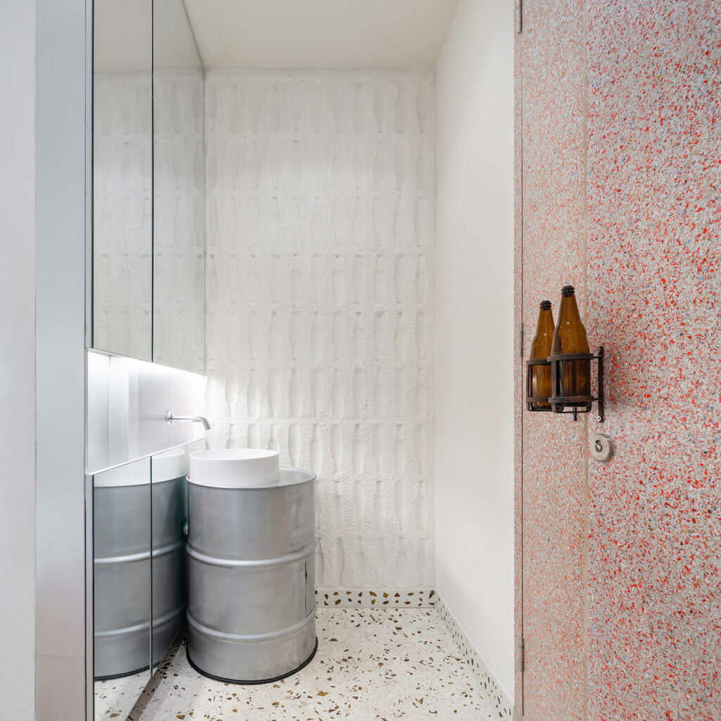 an oil basin is reused as a sink in a cafe bathroom