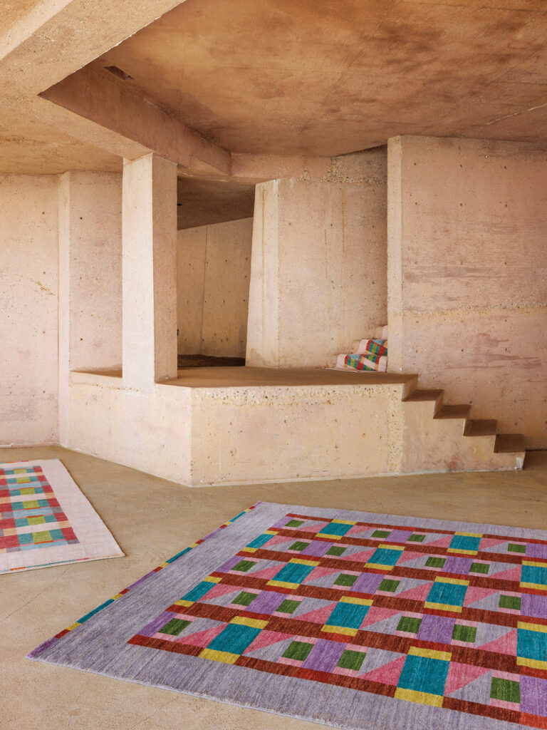 a blue rug with red and green geometric shapes