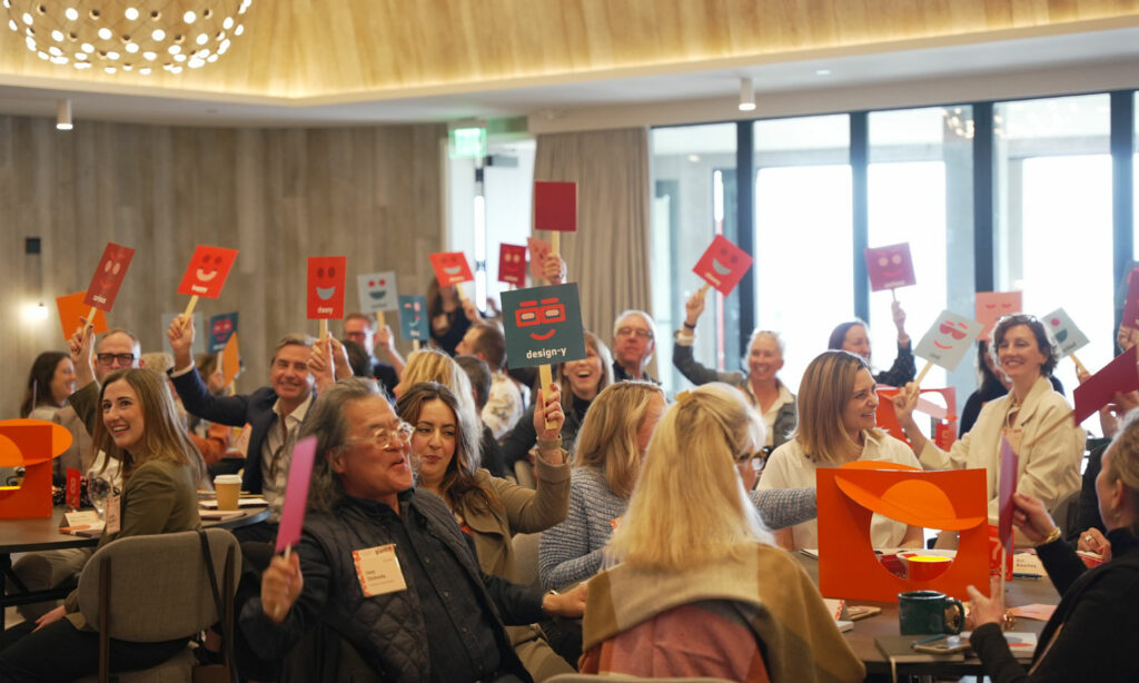 Attendees hold up signs showing their current mood