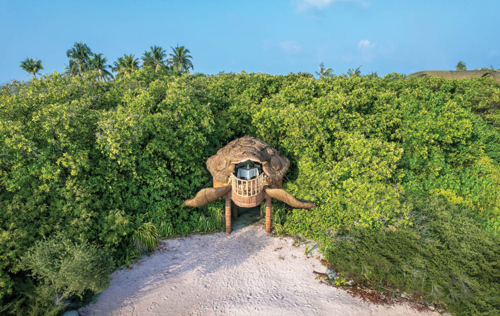 a dining area sahped like a turtle on the sand at Joali Being