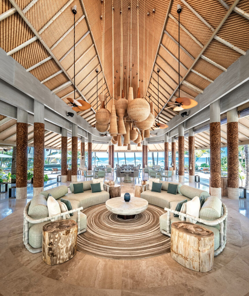 inside the lobby filled with pendant lights and seating options at Joali Being