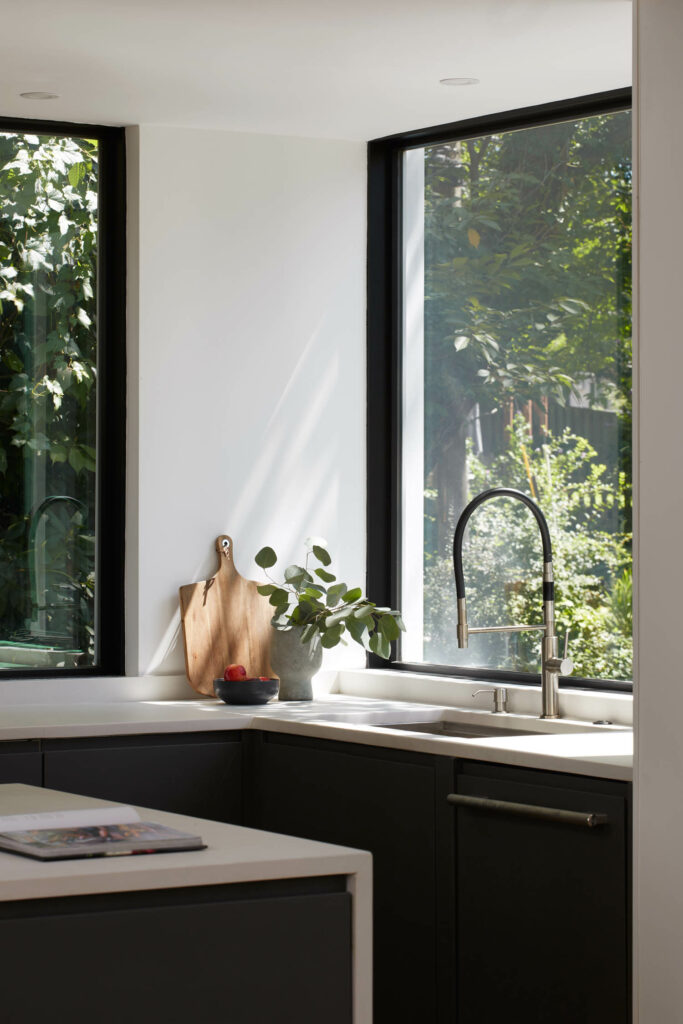 a kitchen in a Maryland home with large windows letting in natural light