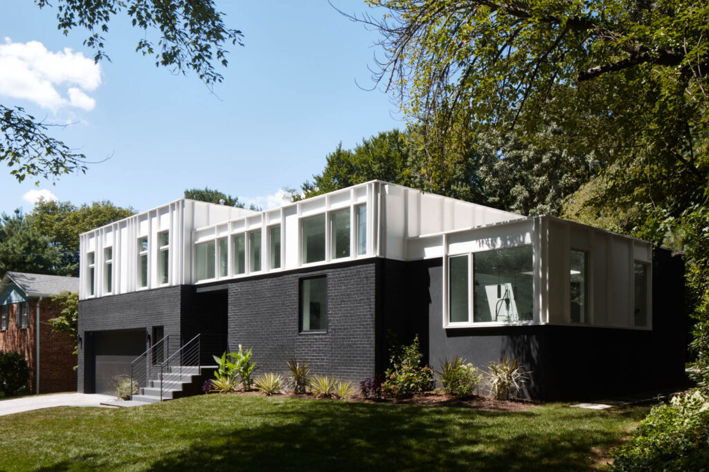 the exterior of a Maryland home with a band of windows above the original brick of the house