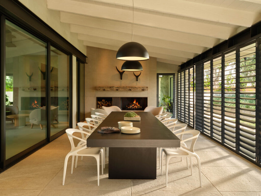 a dining room with a long mahogany table and a fireplace