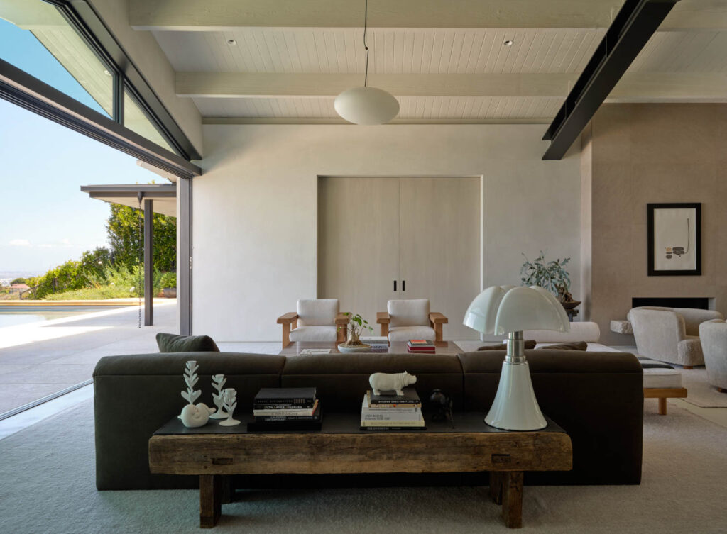 a modern living room with steel beams across the ceiling