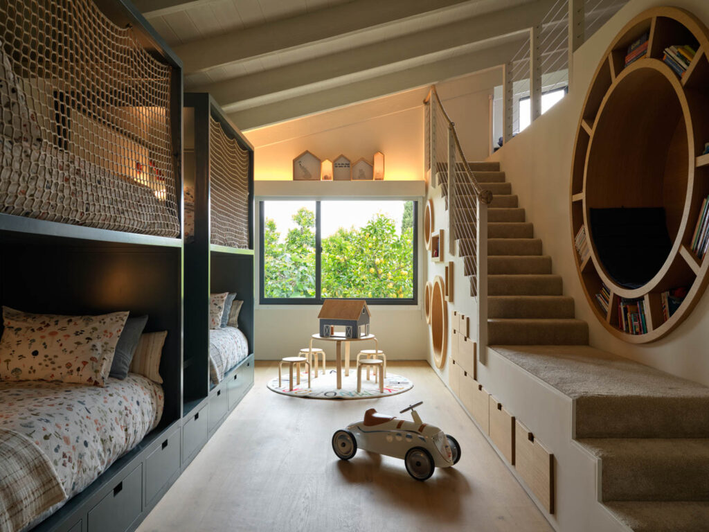 bunk beds line the wall across from a staircase in a SoCal home