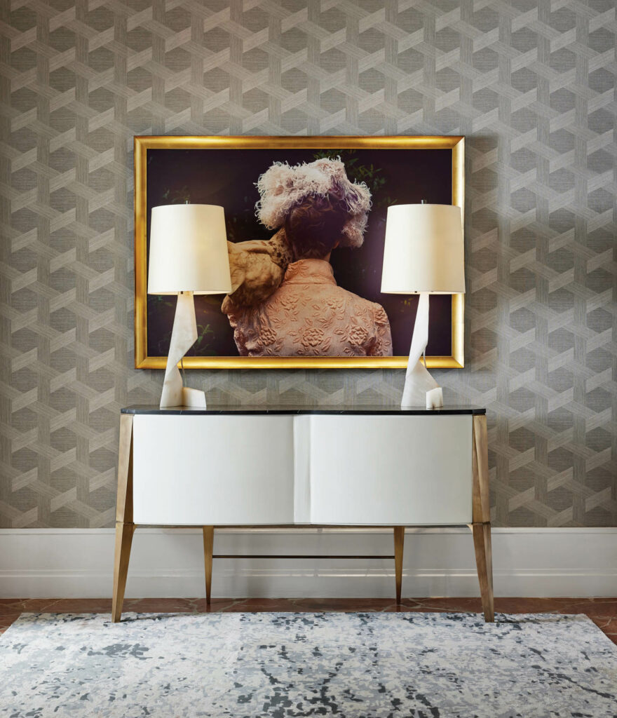 A painting surrounded by two white lamps on a white console in the  InterContinental Buckhead Atlanta