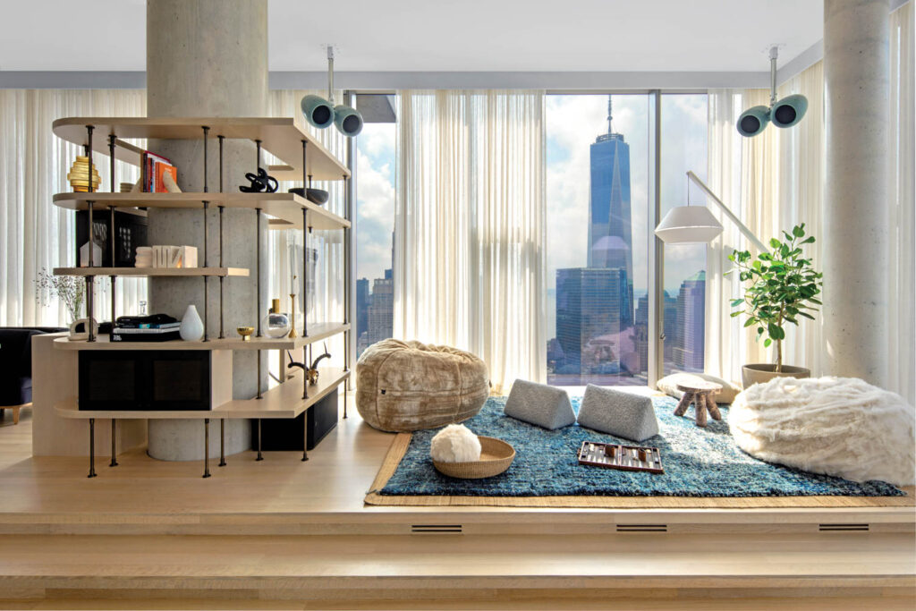 the living room of an NYC penthouse apartment with views of the city