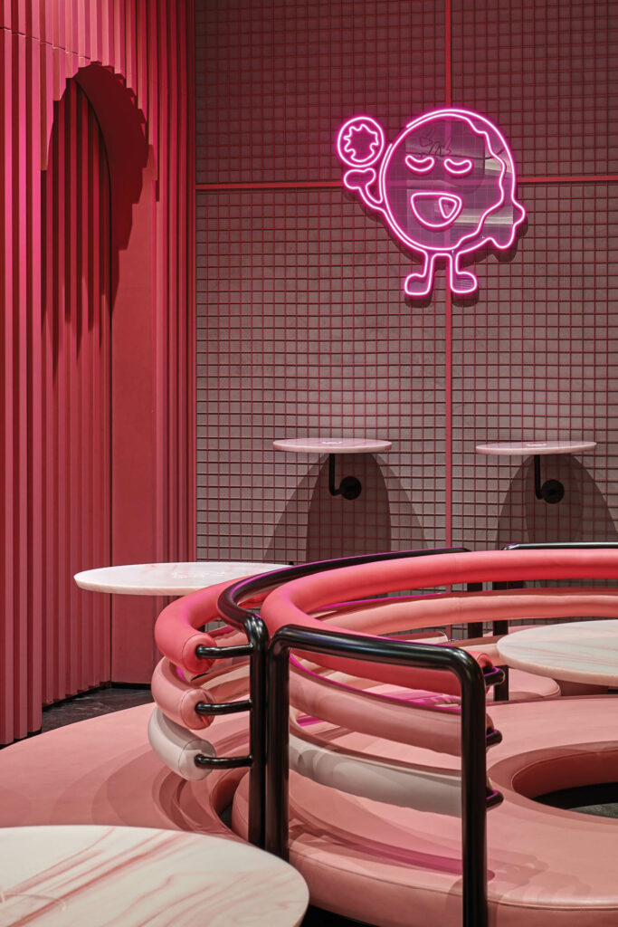 Pink benches curve to mirror the shape of a donut in Here-O dubai