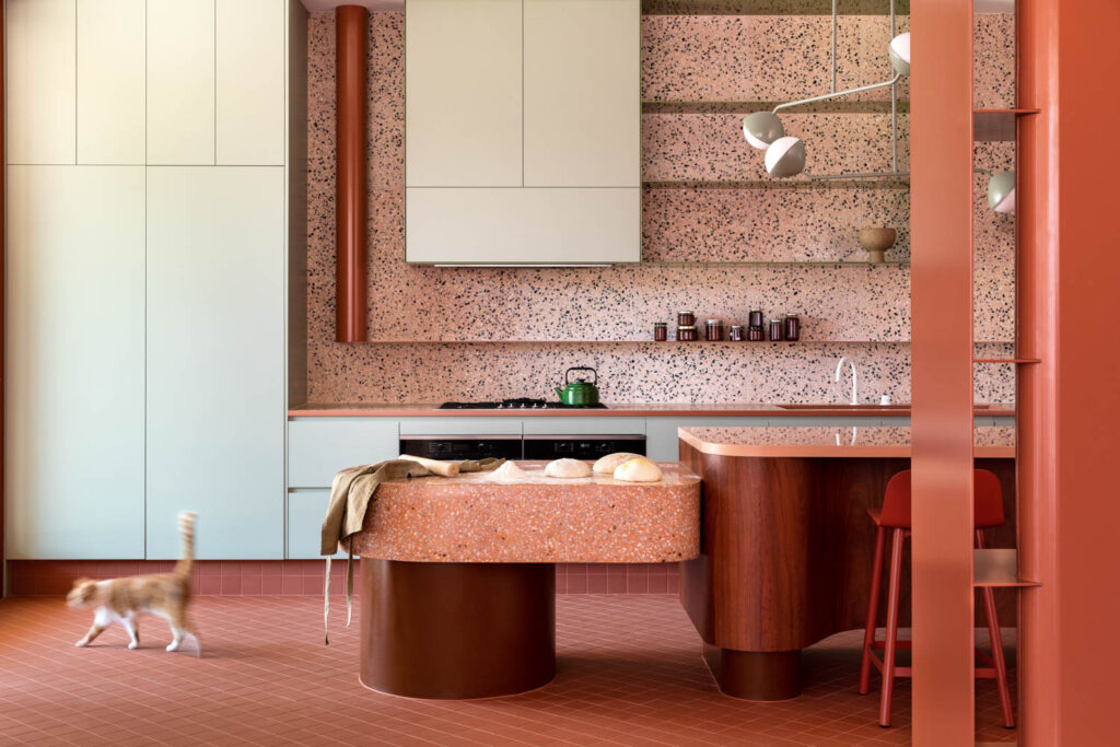 a kitchen with concrete backsplash and matching countertop