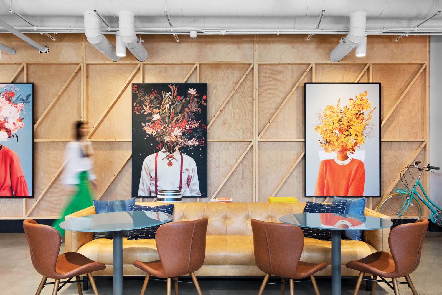 portraits with heads of flowers on the wall of a communal space in an apartment