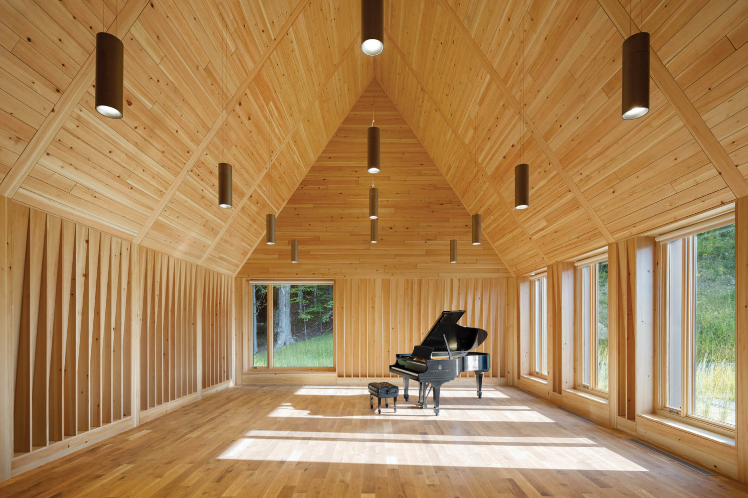 a cedar-clad music rehearsal room with a piano