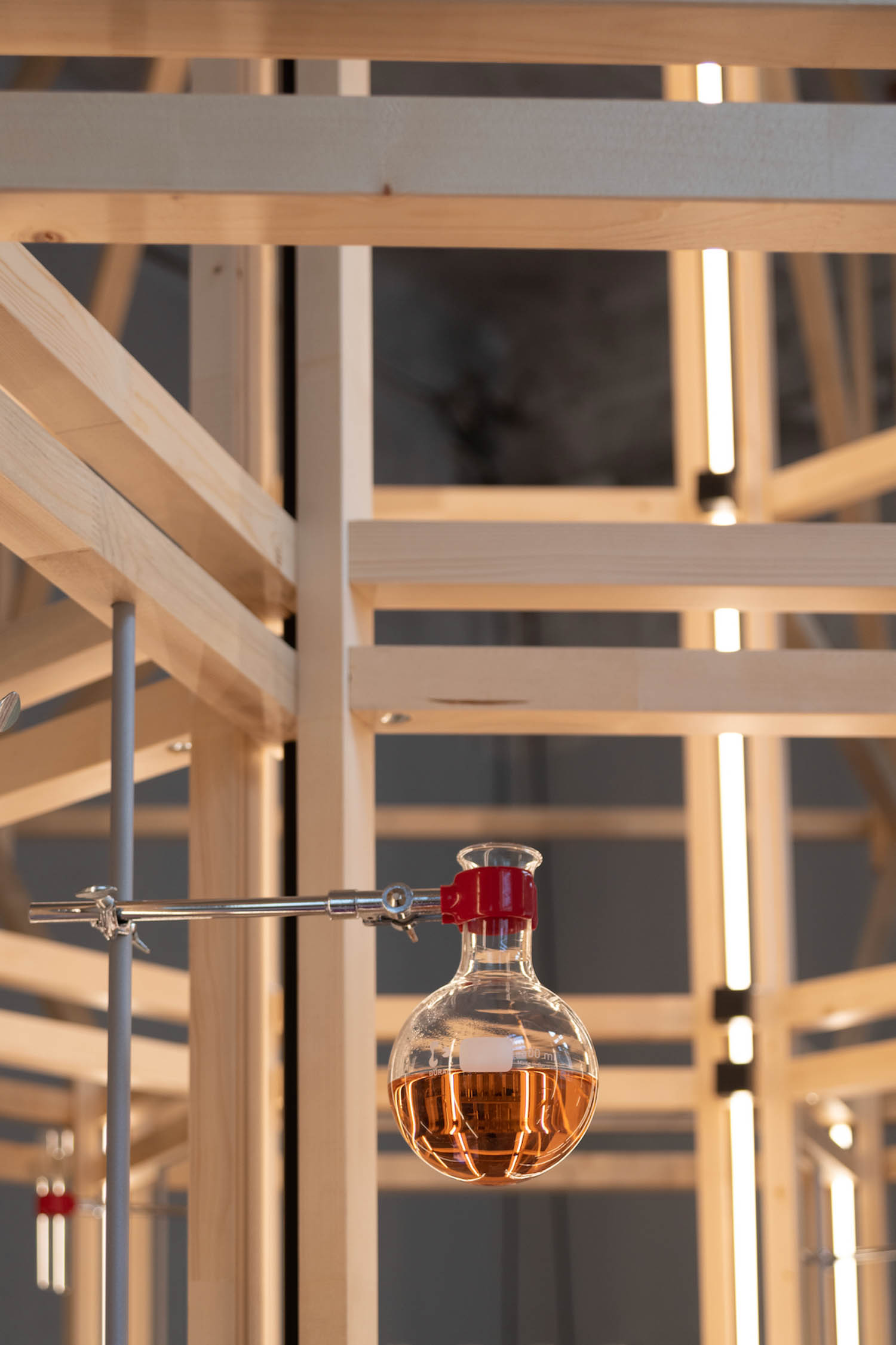 a glass vial holding a substance is part of an installation on scents