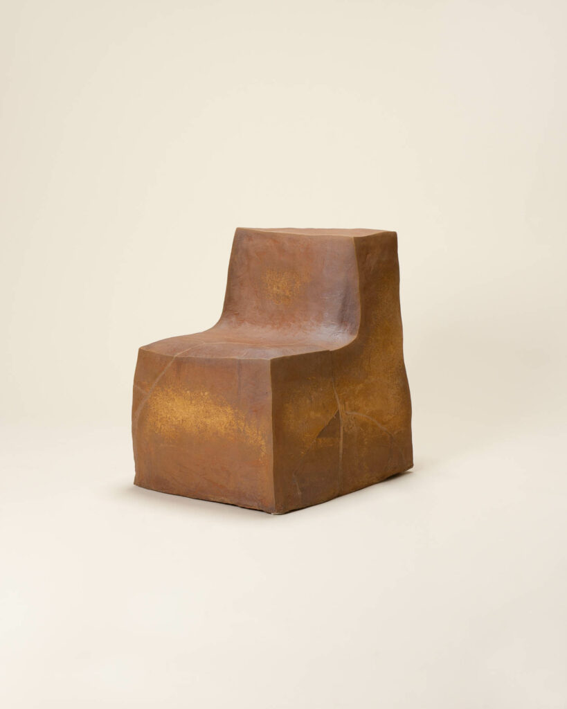 a chair made from cardboard and skimmed in stoneware clay by Isabel Rower