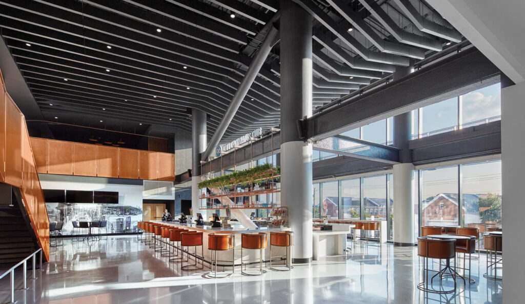 An airy industrial bar area inside the TQL Stadium