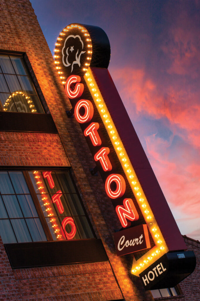 the neon sign of Cotton Court Hotel