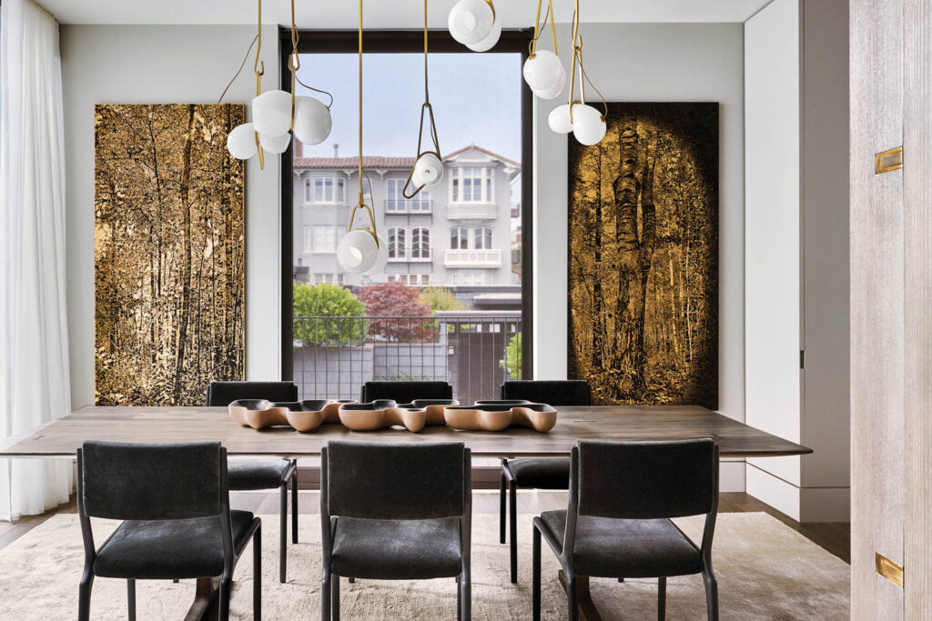 a chandelier hangs above a table in the dining room