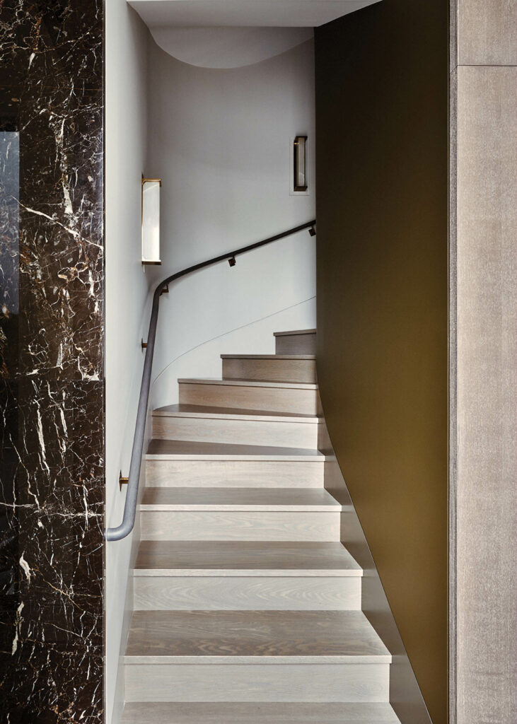 a set of oak stairs inside a home