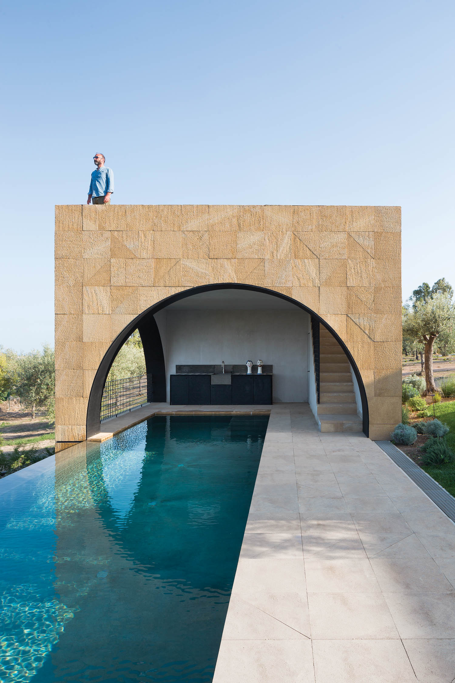 a belvedere partially shades a pool at an Italian villa