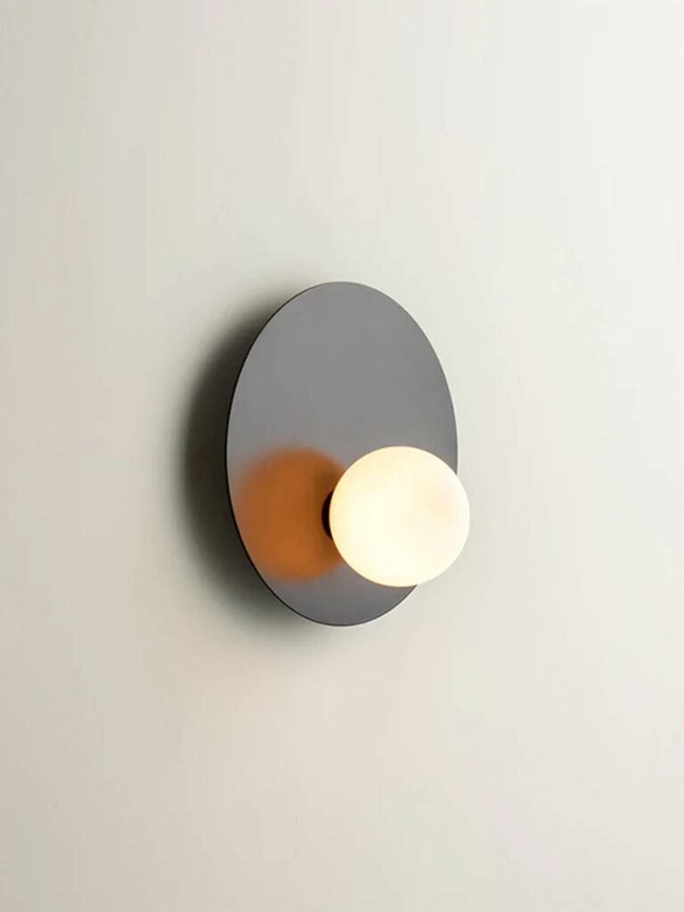 A globe-like sconce on an oval surface