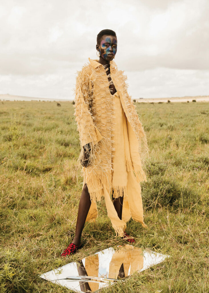 a woman wearing a yellow ensemble by Bubu Ogisi